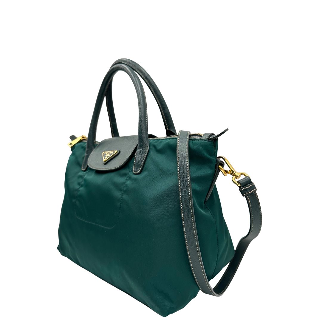 lato Borsa Prada in nylon color ottanio con finiture in pelle tono su tono e parti metalliche dorate; munita di doppi manici stondati e una tracolla amovibile e regolabile. Completa di dustbag, di lusso, originale, ottime condizioni. 