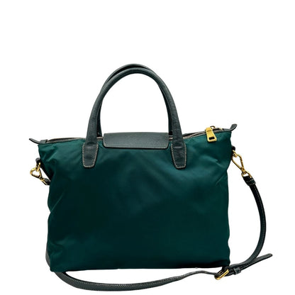 retro Borsa Prada in nylon color ottanio con finiture in pelle tono su tono e parti metalliche dorate; munita di doppi manici stondati e una tracolla amovibile e regolabile. Completa di dustbag, di lusso, originale, ottime condizioni. 