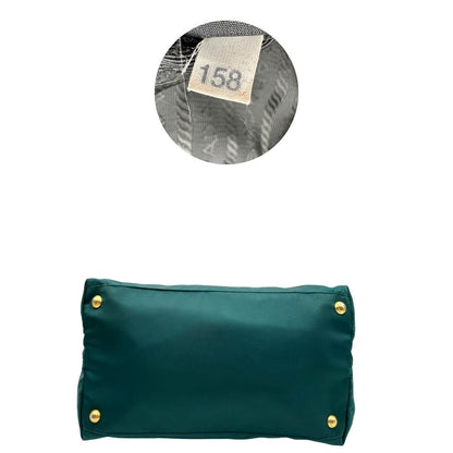 base Borsa Prada in nylon color ottanio con finiture in pelle tono su tono e parti metalliche dorate; munita di doppi manici stondati e una tracolla amovibile e regolabile. Completa di dustbag, di lusso, originale, ottime condizioni. 