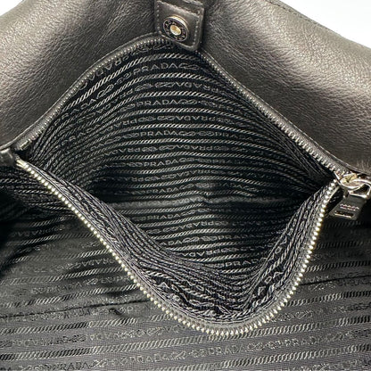 interno Borsa Prada in pelle nera con parti metalliche argentate; munita di doppi manici in pelle e catena intrecciati, da portare a spalla, di lusso, originale, ottime condizioni, usata.