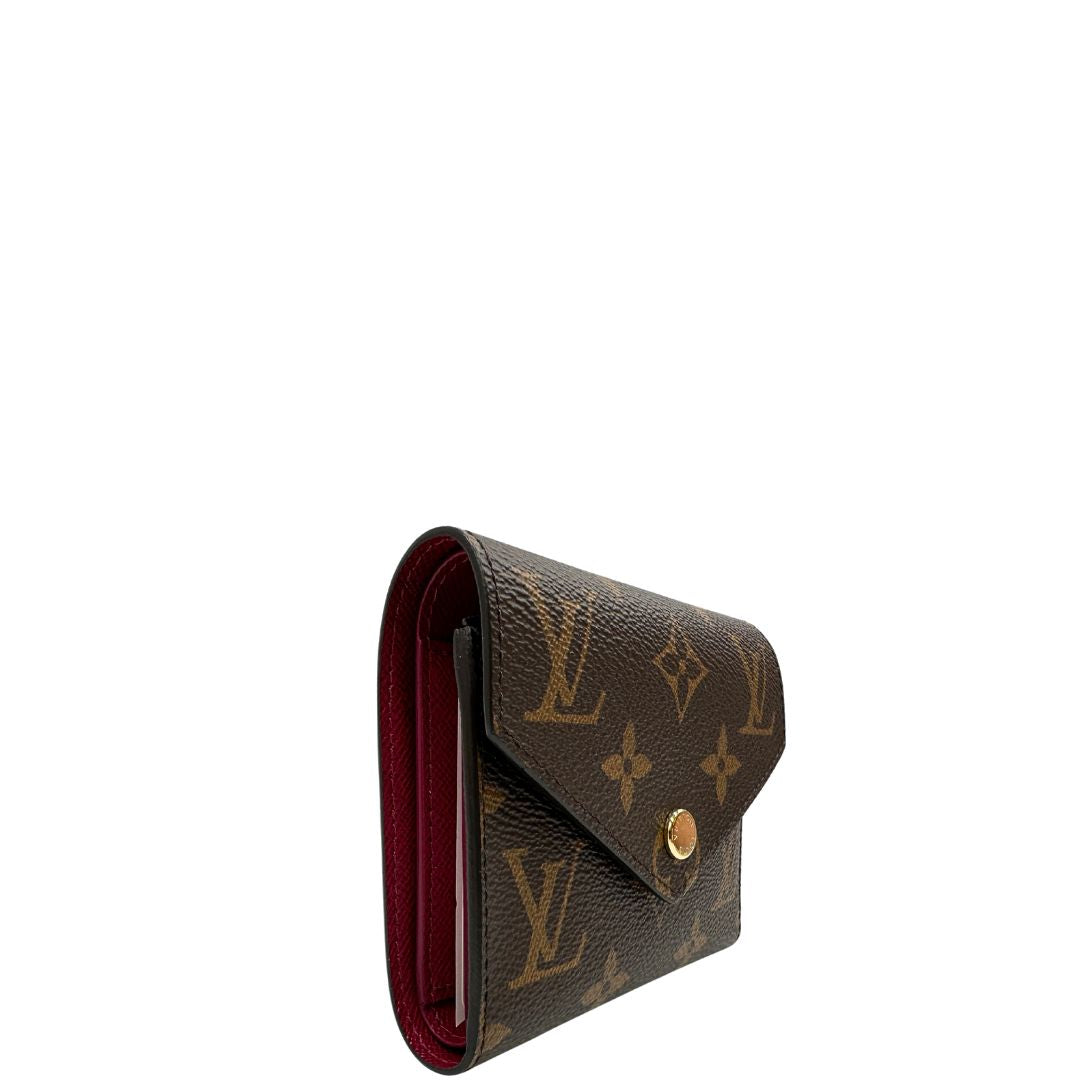 lato Portafoglio Louis Vuitton in canvas marrone monogram con parti metalliche dorate. Completo di corredo, di lusso, originale, eccellenti condizioni. 