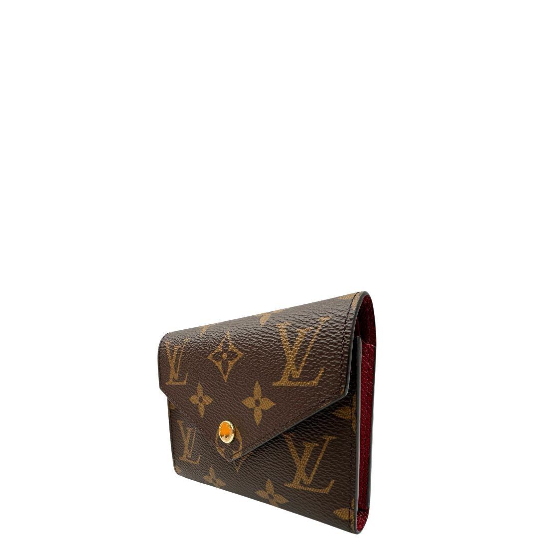 lato Portafoglio Louis Vuitton in canvas marrone monogram con parti metalliche dorate. Completo di corredo, di lusso, originale, eccellenti condizioni.