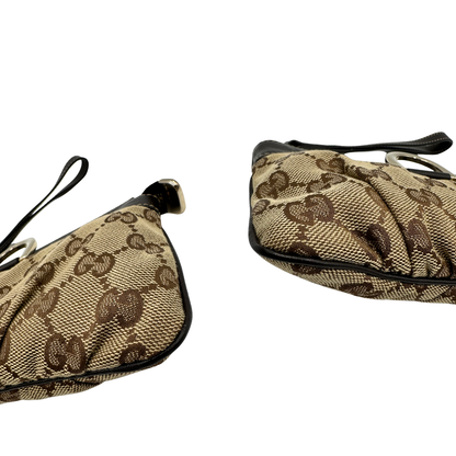 angoli Pochette Gucci in tessuto Gucci in tessuto GG beige con finiture in pelle marroni e parti metalliche dorate; munita di un polsino, da portare a mano. Completa di corredo, di lusso, originale, ottime condizioni. 