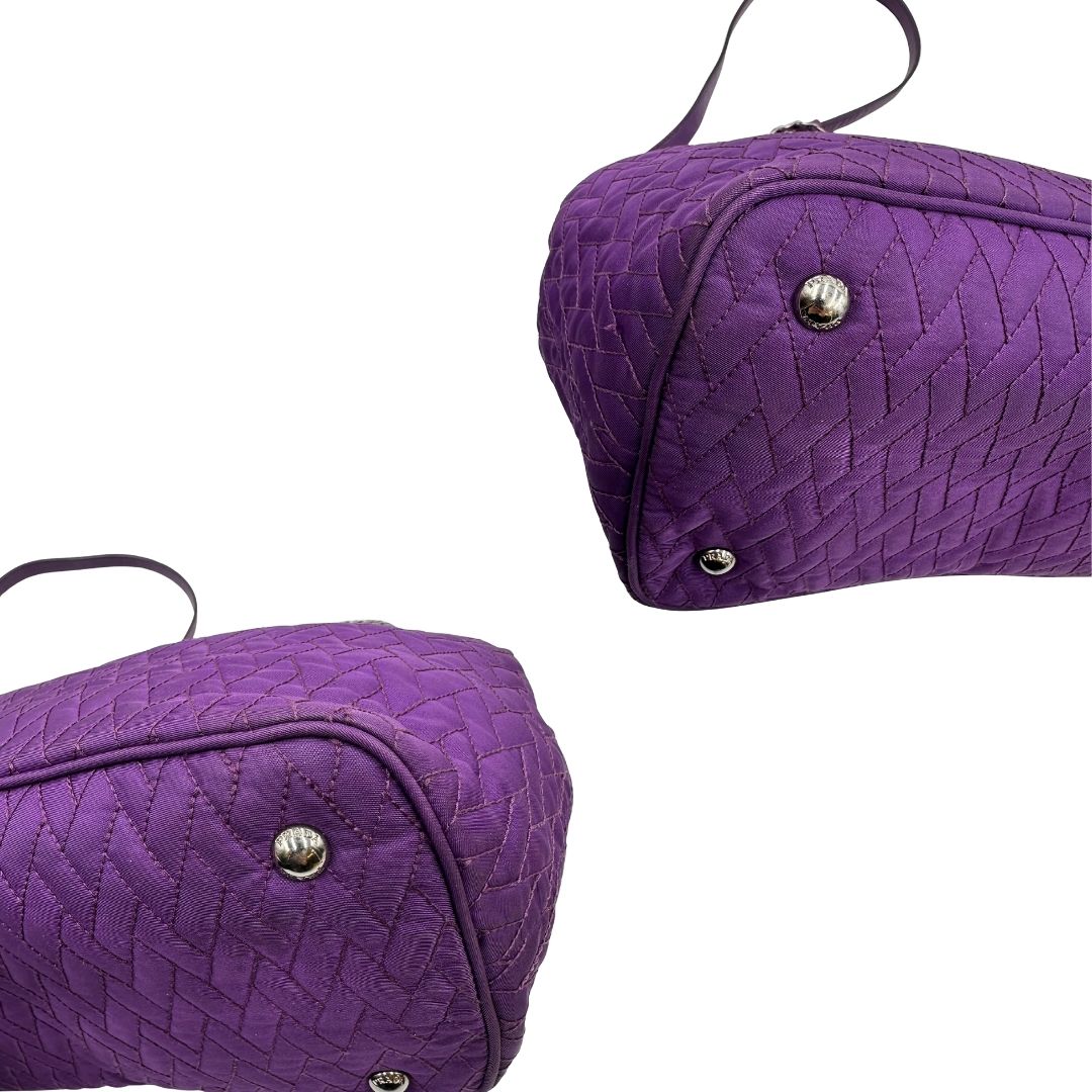 angoli Borsa Prada in nylon viola con finiture in pelle tono su tono e parti metalliche argentate; munita di doppi manici in catena e pelle intrecciati e una tracolla amovibile e regolabile. Completa di dustbag, di lusso, originale, ottime condizioni, usata, originale.