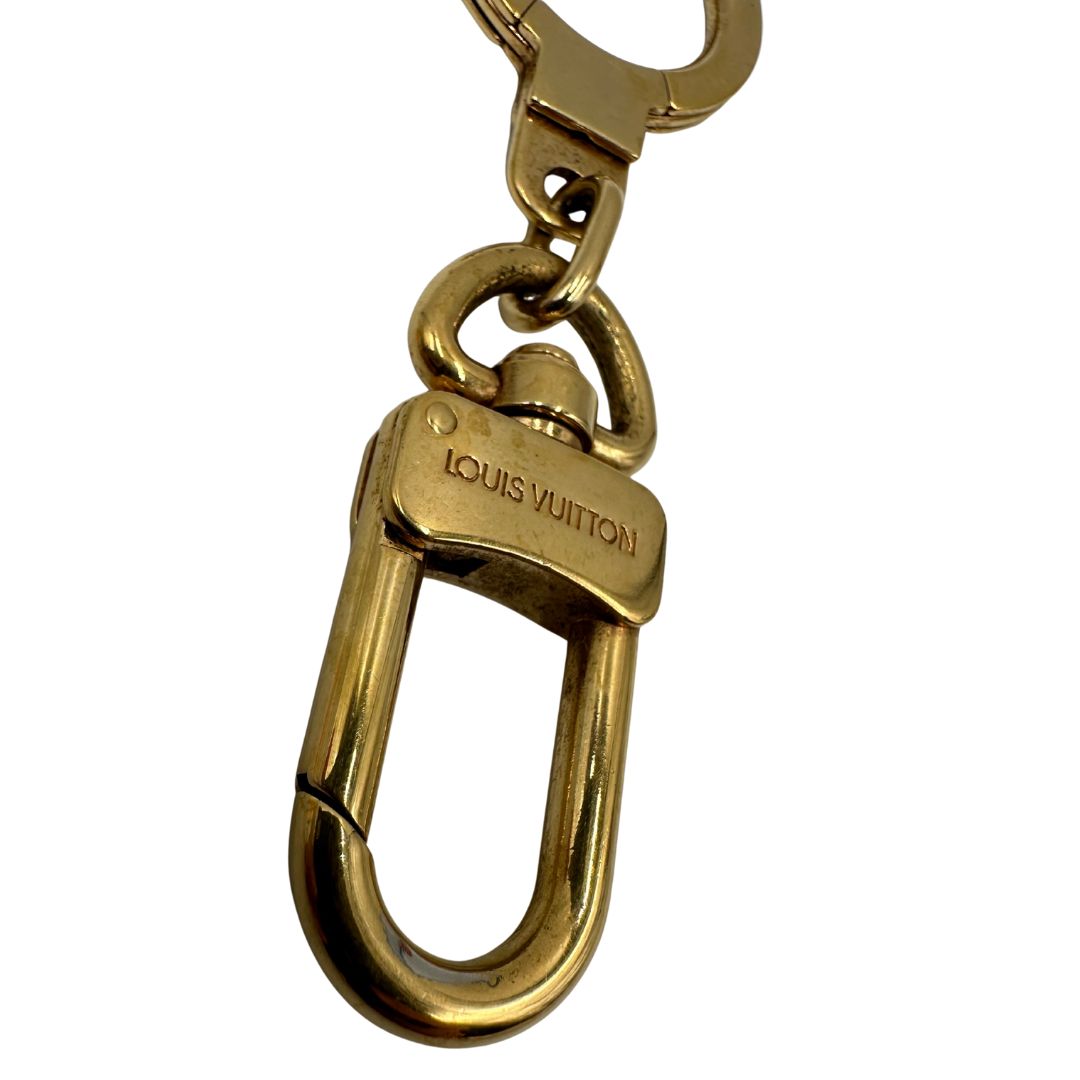 Charm Louis Vuitton in metallo dorato. Completo di scatola e sacchetto antipolvere, di lusso, usato, originale. 