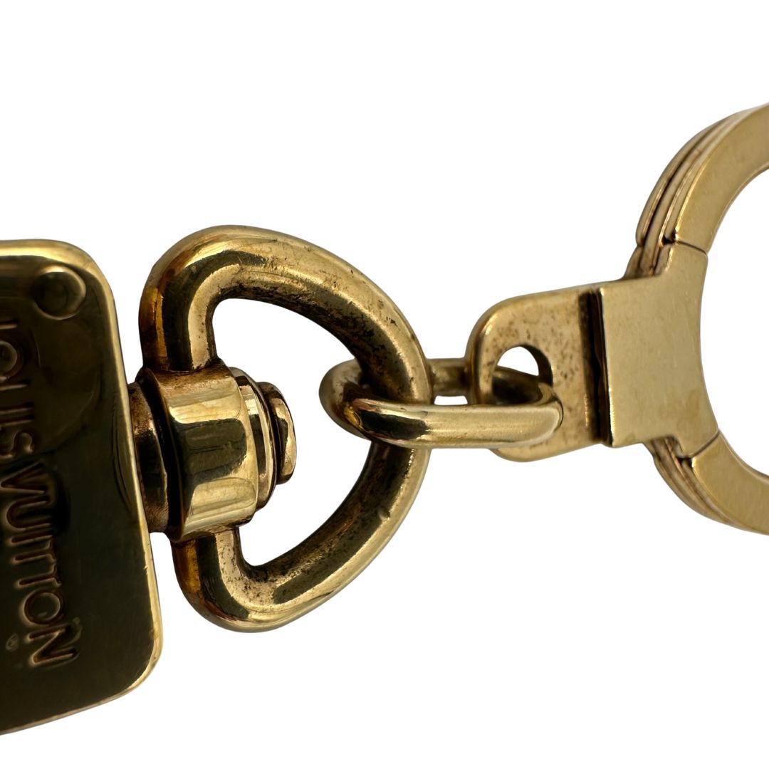 Charm Louis Vuitton in metallo dorato. Completo di scatola e sacchetto antipolvere, di lusso, usato, originale. 