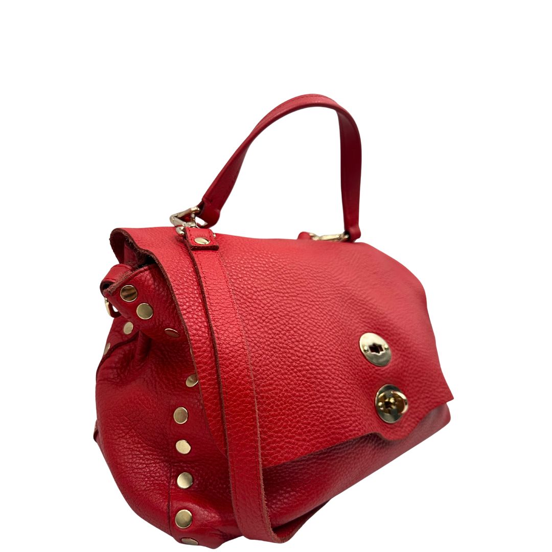 lato Borsa Zanellato in pelle martellata rossa con parti metalliche dorate; munita di un manico singolo e una tracolla amovibile e regolabile. Completa di dustbag, di lusso, originale, ottime condizioni, usata. 