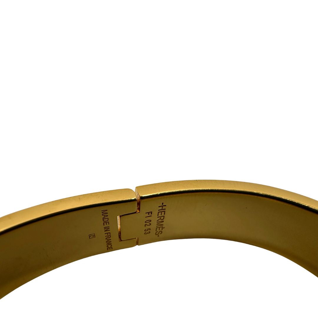 Bracciale Hèrmes in metallo dorato con smalto opaco blu. Completo di corredo, di lusso, originale, ottime condizioni.