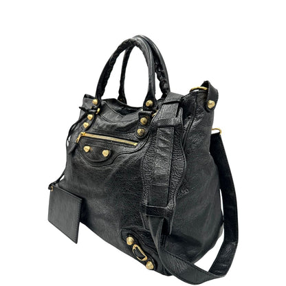 lato Borsa Balenciaga in pelle crinkled nera con parti metalliche dorate; munita di doppi manici stondati con trama a intreccio e una tracolla amovibile e regolabile. Completa di dustbag, di lusso, originale, ottime condizioni 