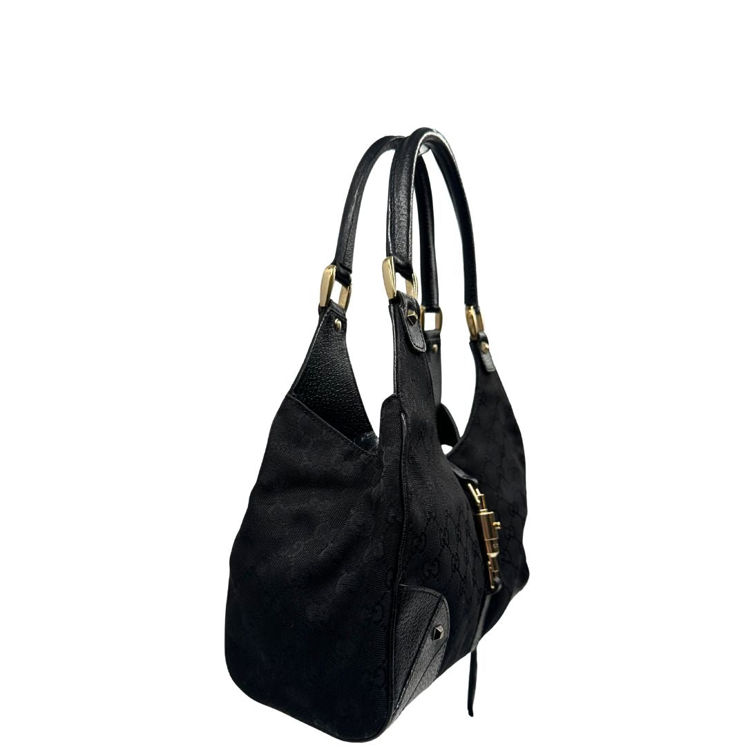 lato Borsa Gucci in tessuto GG nero con finiture in pelle tono su tono e parti metalliche dorate; munita di doppi manici stondati. Completa di dustbag, di lusso, originale, ottime condizioni. 
