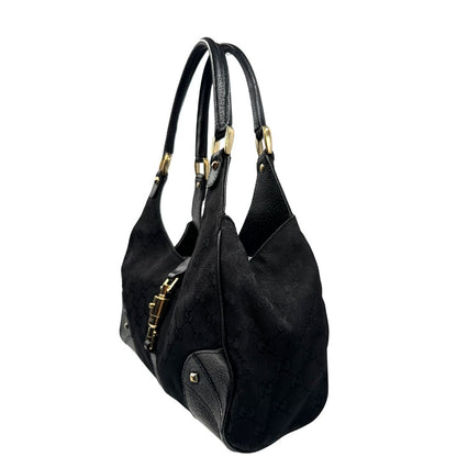 lato Borsa Gucci in tessuto GG nero con finiture in pelle tono su tono e parti metalliche dorate; munita di doppi manici stondati. Completa di dustbag, di lusso, originale, ottime condizioni. 