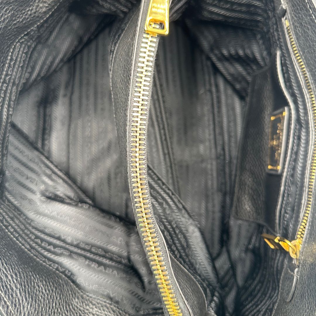 interno Borsa Prada in pelle martellata nera con parti metalliche dorate; munita di una tracolla amovibile e regolabile e doppi manici stondati, di lusso, originale, usata 