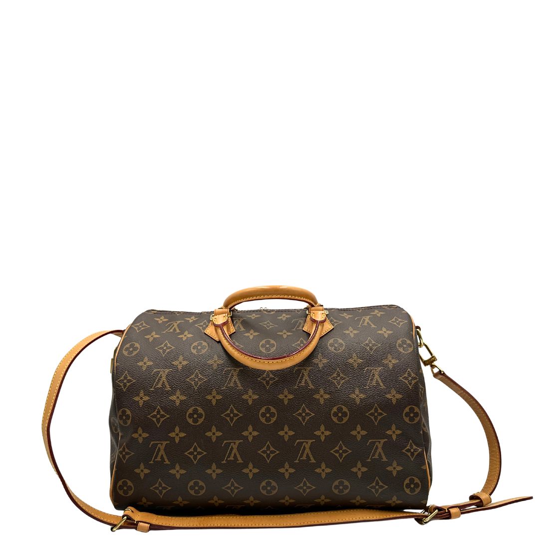 retro Borsa Speedy 35 in canvas marrone monogram con finiture in vacchetta naturale e parti metalliche dorate; munita di doppi manici stondati e una tracolla amovibile e regolabile. Completa di corredo, lucchetto e chiavi, di lusso, originale, ottime condizioni. 