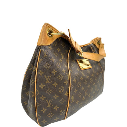 lato Borsa Louis Vuitton in canvas marrone monogram con finiture in vacchetta naturale e parti metalliche dorate; munita di un manico singolo leggermente regolabile, di lusso, originale, ottime condizioni, usata. 