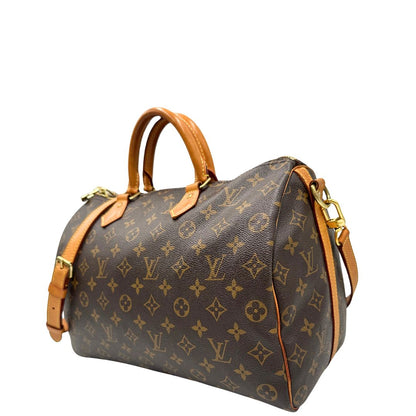 lato Borsa Speedy 35 in canvas marrone monogram con finiture in vacchetta naturale e parti metalliche dorate; munita di doppi manici stondati e una tracolla amovibile e regolabile. Completa di lucchetto e dustbag, di lusso, originale, ottime condizioni. 