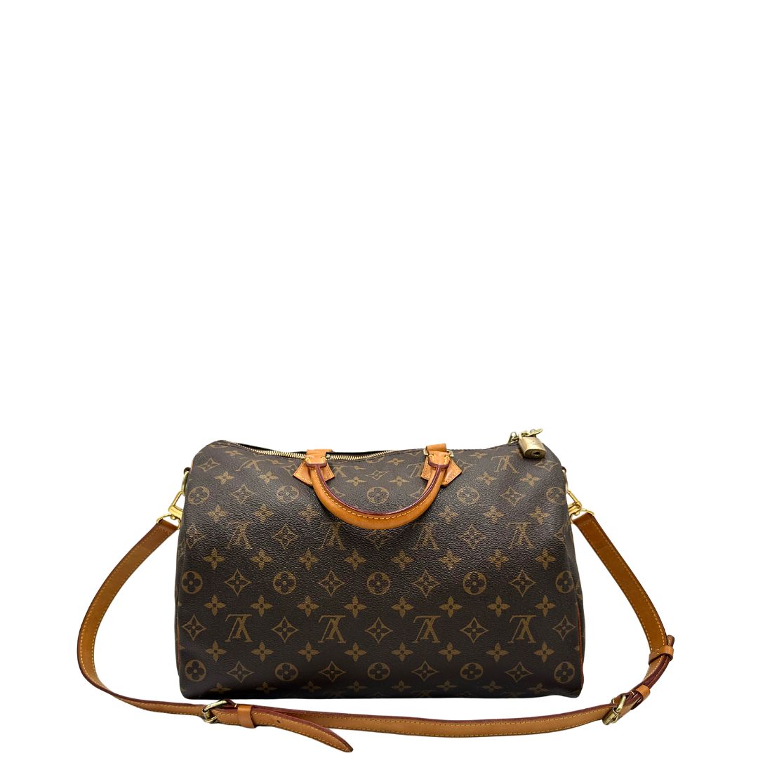 retro Borsa Speedy 35 in canvas marrone monogram con finiture in vacchetta naturale e parti metalliche dorate; munita di doppi manici stondati e una tracolla amovibile e regolabile. Completa di lucchetto e dustbag, di lusso, originale, ottime condizioni. 