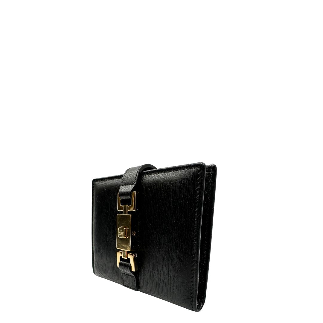 Agenda Gucci in pelle nera con parti metalliche dorate, munita di un pennino, di lusso, originale