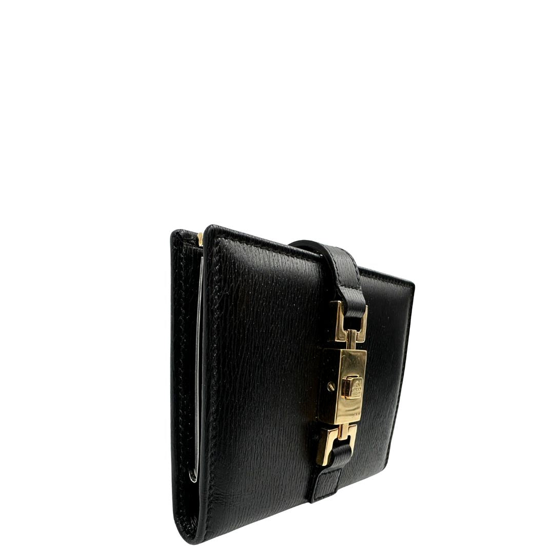 Agenda Gucci in pelle nera con parti metalliche dorate, munita di un pennino, di lusso, originale