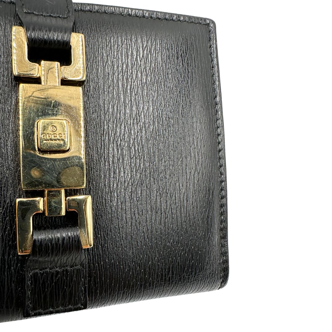 Agenda Gucci in pelle nera con parti metalliche dorate, munita di un pennino, di lusso, originale