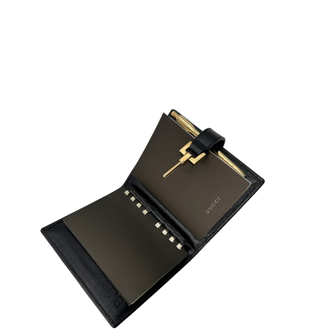 Agenda Gucci in pelle nera con parti metalliche dorate, munita di un pennino, di lusso, originale