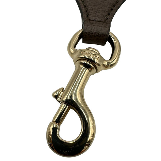 Tracolla Gucci in tessuto con iconica striscia web verde e rossa, con parti in pelle marrone e parti metalliche dorate, di lusso, originale, usata.