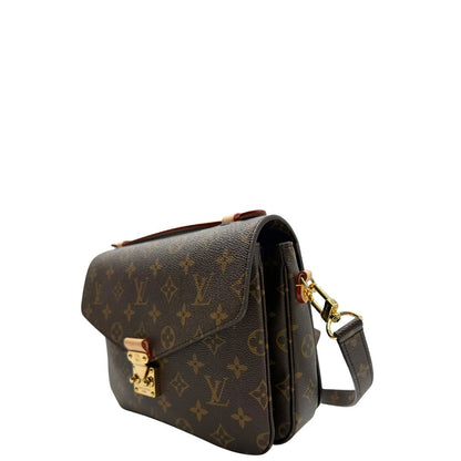 Lato sinistro di una Borsa Louis Vuitton Métis in canvas marrone monogram con dettagli in vacchetta naturale e parti metalliche dorate. Munita di un manico singolo e una tracolla regolabile e amovibile. Dotata di busta, scatola e dustbag. PRESENZA DI NFC .Originale, usata, di lusso, in ottime condizioni.