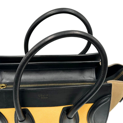 manici Borsa Céline Luggage in pelle multicolr nera, gialla e laterali in pelle scamosciata beige, con parti metalliche dorate e doppi manici stondati. Completa di dustbag, di lusso, originale, ottime condizioni, usata. 