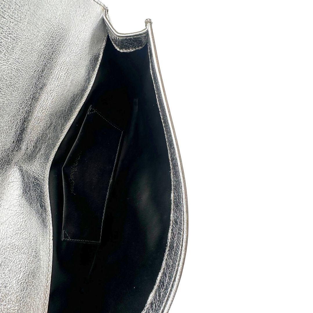 interno Pochette Saint Laurent in pelle argentata effetto invecchiato, impreziosita dal logo Cassandre sul front. Completa di dustbag, di lusso, originale, ottime condizioni, usata. 