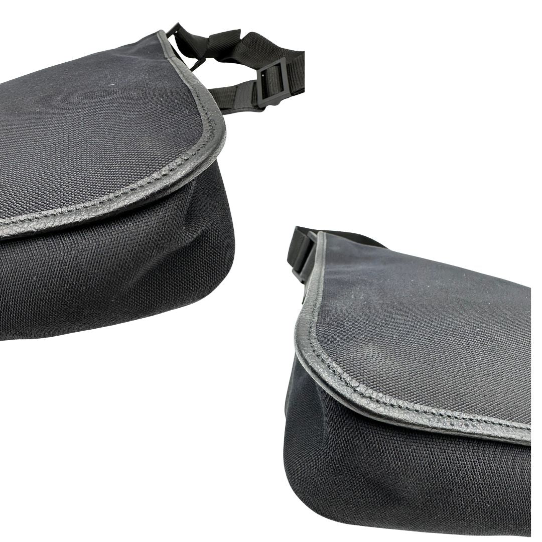 angoli Borsa Gucci in tessuto nero con finiture in pelle tono su tono; munita di una tracolla in tessuto regolabile, di lusso, originale, ottime condizioni, usata.