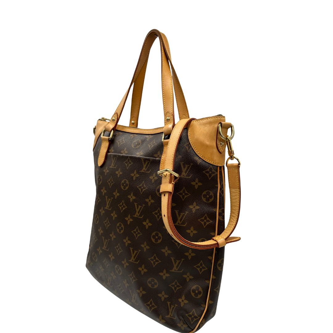 lato Borsa Louis Vuitton Métis in canvas marrone monogram con dettagli in vacchetta naturale e parti metalliche dorate. Munita di doppi manici e una tracolla regolabile e amovibile, di lusso, originale, ottime condizioni, usata, originale. 