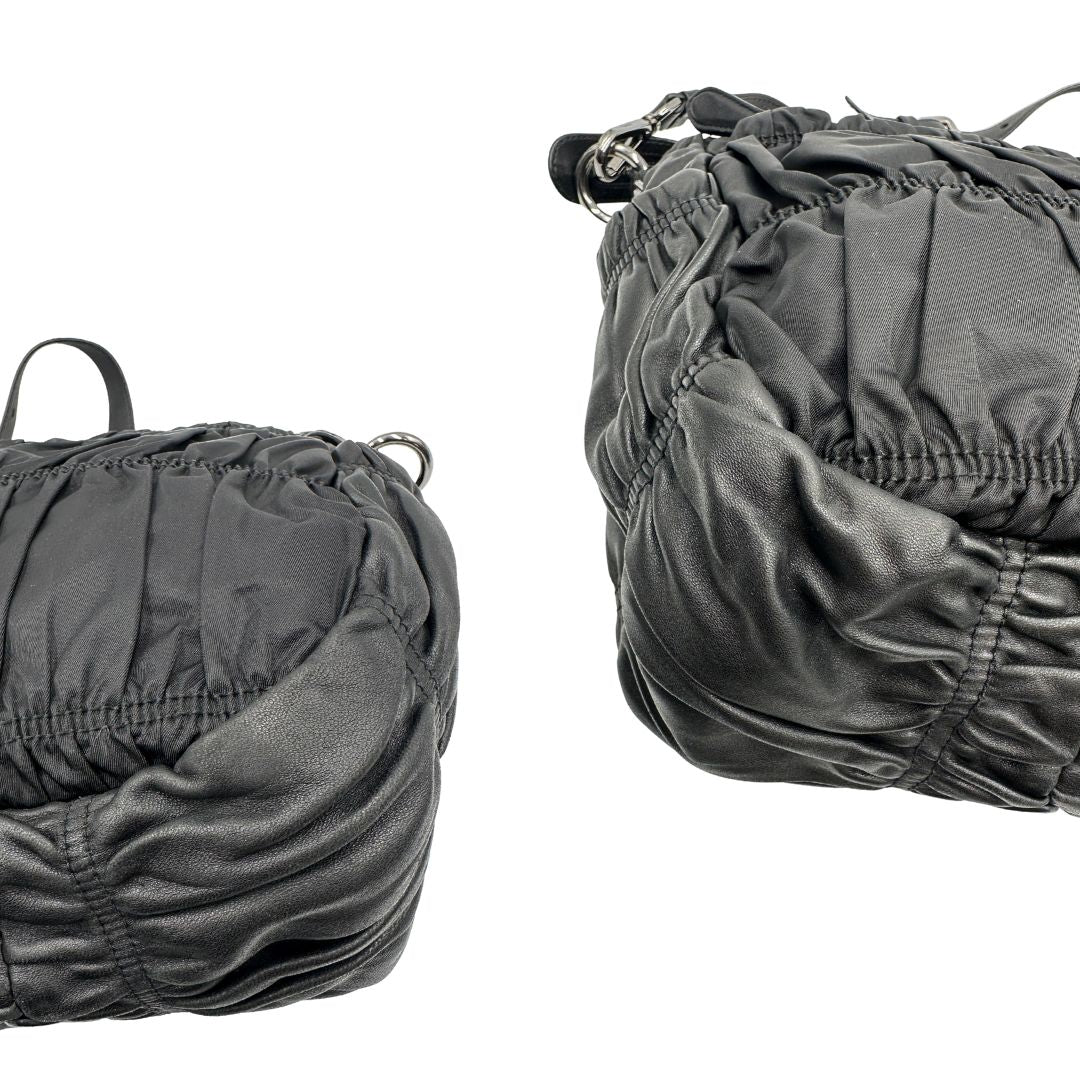 Angoli di una Borsa Prada in tessuto nylon goffrato nero con parti metalliche argentate e inserti in pelle tono su tono, munita di una tracolla regolabile e amovibile. Completa di dustbag. Originale, usata, di lusso, in ottime condizioni.