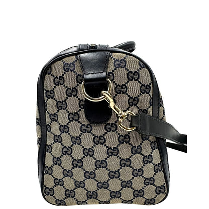 lato  Borsa Gucci in tessuto blu GG con finiture in pelle tono su tono, parti metalliche dorate e striscia Web blu e rossa; munita di doppi manici stondati e una tracolla amovibile e regolabile. Completa di dustbag, di lusso, originale, ottime condizioni, usata. 