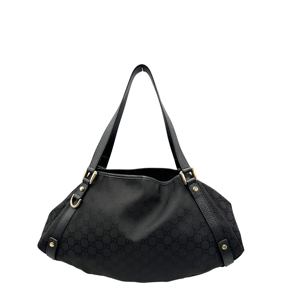 front  Borsa Gucci in tessuto nero GG con finiture in pelle tono su tono e parti metalliche dorate; munita di doppi manici, indossabile a spalla. Completa di dustbag, di lusso, originale, ottime condizioni, usata. 