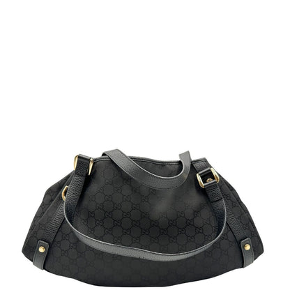 retro  Borsa Gucci in tessuto nero GG con finiture in pelle tono su tono e parti metalliche dorate; munita di doppi manici, indossabile a spalla. Completa di dustbag, di lusso, originale, ottime condizioni, usata. 
