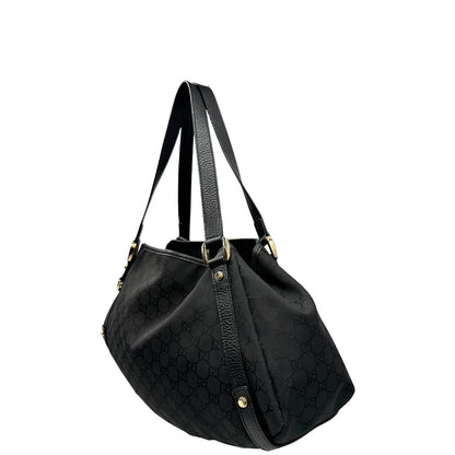 lato  Borsa Gucci in tessuto nero GG con finiture in pelle tono su tono e parti metalliche dorate; munita di doppi manici, indossabile a spalla. Completa di dustbag, di lusso, originale, ottime condizioni, usata. 