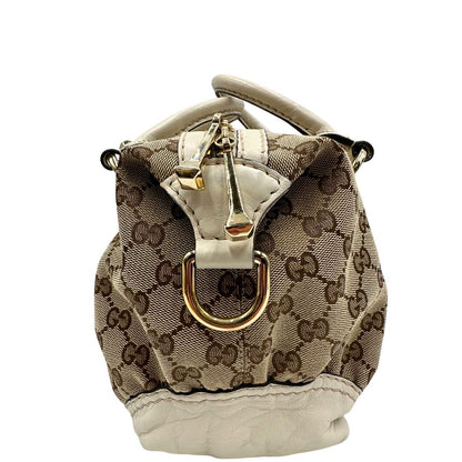 lato  Borsa Gucci in tessuto GG beige con finiture in pelle color avorio e parti metalliche; munita di doppi manici stondati, da portare a mano. Completa di dustbag, di lusso, originale, ottime condizioni, usato. 