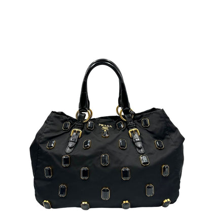 front  Borsa Prada in nylon nero con parti metalliche dorate e manici in pelle lucida; impreziosita da pietre su tutta la superficie del front; munita di doppi manici stondati, di lusso, originale, ottime condizioni, usata. 