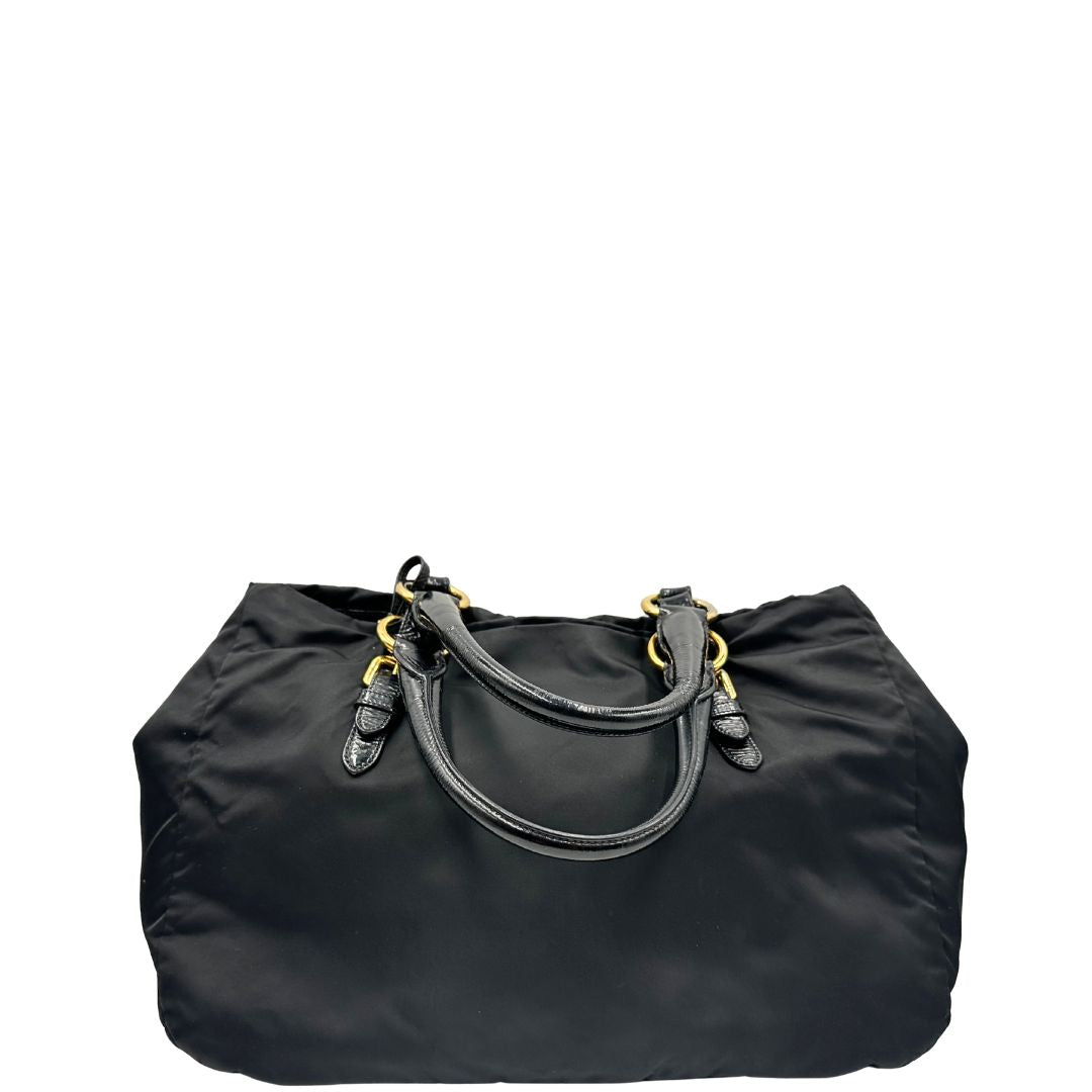 retro  Borsa Prada in nylon nero con parti metalliche dorate e manici in pelle lucida; impreziosita da pietre su tutta la superficie del front; munita di doppi manici stondati, di lusso, originale, ottime condizioni, usata. 
