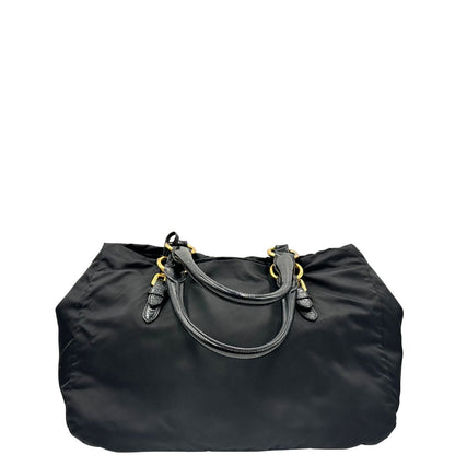 retro  Borsa Prada in nylon nero con parti metalliche dorate e manici in pelle lucida; impreziosita da pietre su tutta la superficie del front; munita di doppi manici stondati, di lusso, originale, ottime condizioni, usata. 