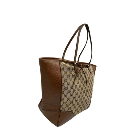 lato Borsa Gucci in tessuto GG con finiture in pelle marroni e parti metalliche dorate; munita di doppi manici, indossabile a spalla. Completa di dustbag, di lusso, buone condizioni,usata. 