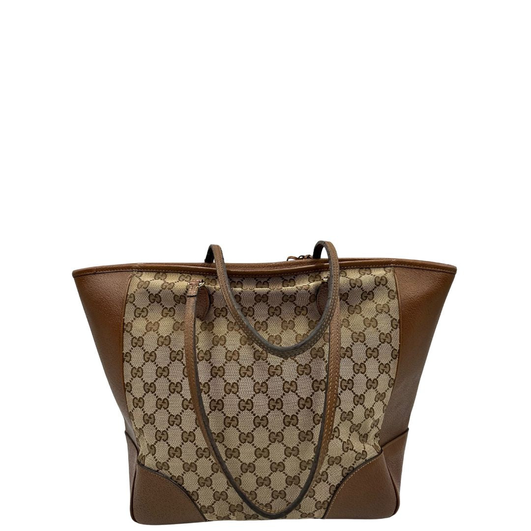 retro Borsa Gucci in tessuto GG con finiture in pelle marroni e parti metalliche dorate; munita di doppi manici, indossabile a spalla. Completa di dustbag, di lusso, buone condizioni,usata. 