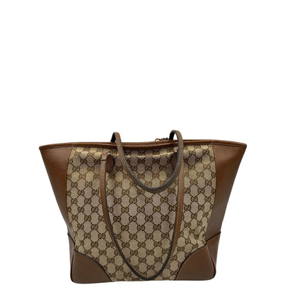 retro Borsa Gucci in tessuto GG con finiture in pelle marroni e parti metalliche dorate; munita di doppi manici, indossabile a spalla. Completa di dustbag, di lusso, buone condizioni,usata. 