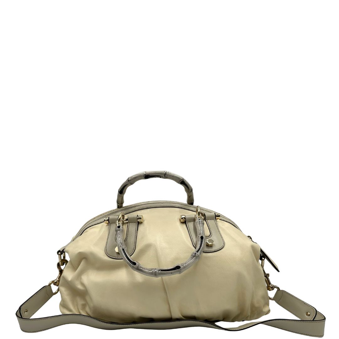 Retro di una Borsa Gucci in pelle bianco panna con metalleria in oro dorato e inserti in pelle avorio, munita di doppi manici in bamboo e tracolla amovibile. Completa di dutsbag. Originale, usata, di lusso, in ottime condizioni.