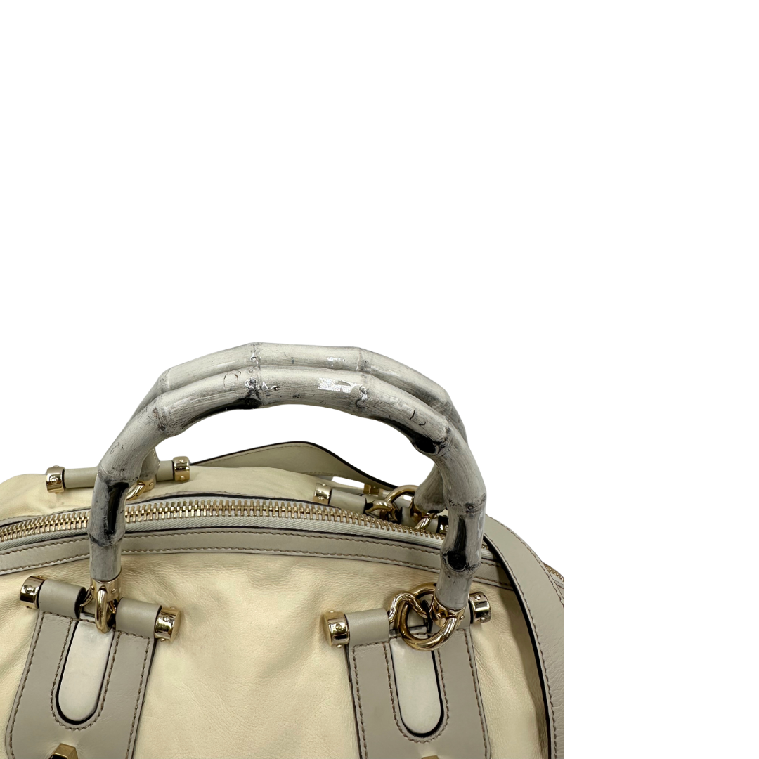 Manici di una Borsa Gucci in pelle bianco panna con metalleria in oro dorato e inserti in pelle avorio, munita di doppi manici in bamboo e tracolla amovibile. Completa di dutsbag. Originale, usata, di lusso, in ottime condizioni.