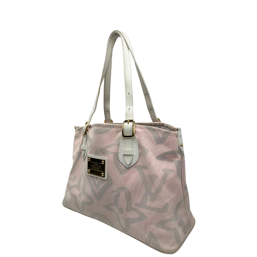 Lato sinistro, Borsa Louis Vuitton in tela resistente bicolore con motivi floreali coordinati.