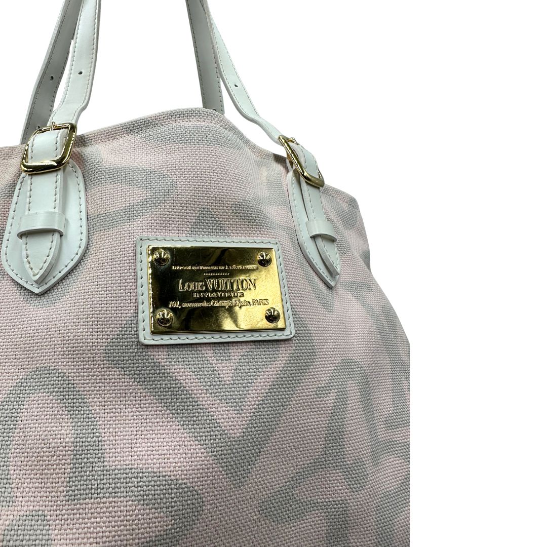 Borsa Louis Vuitton in tela resistente bicolore con motivi floreali coordinati.