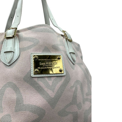 Borsa Louis Vuitton in tela resistente bicolore con motivi floreali coordinati.