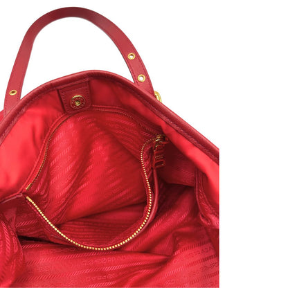 Interno di una borsa Prada in nylon rosso e finiture in pelle saffiano tono su tono, usata, originale, second hand, in ottime condizioni.