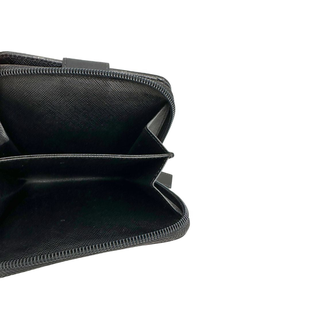 Interno, Portafoglio Prada in nylon nero con chiusura a zip e l'iconico logo triangolare in metallo. Originale, usato, di lusso, in ottime condizioni.