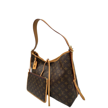 lato  La borsa CarryAll MM è realizzata in tela Monogram e rifinita in pelle naturale, di lusso, originale, ottime condizioni, usata. 